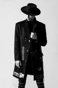 male model in grunge fashion posing black and white