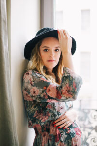 hipster model in floral outfit posing